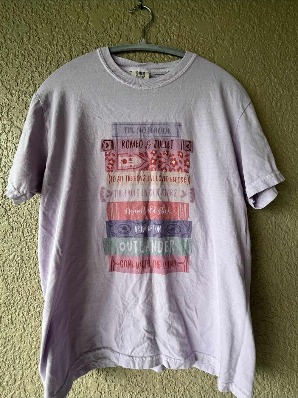 Lavender Book Graphic Tee with Multi-Color Bookstack Design